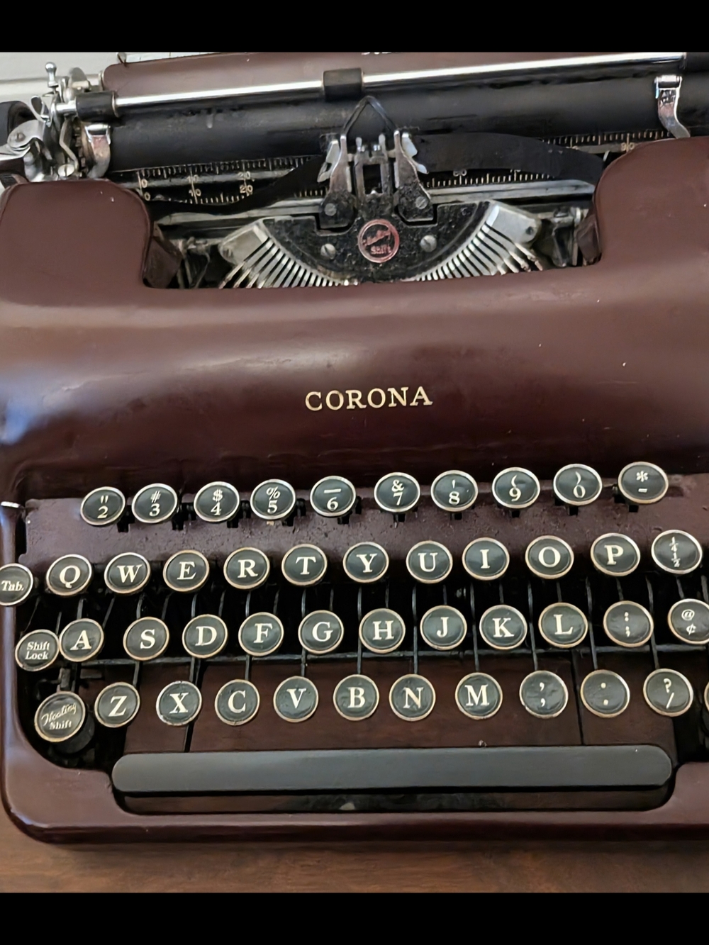 Corona typewriter in brown and black with cream key faces
